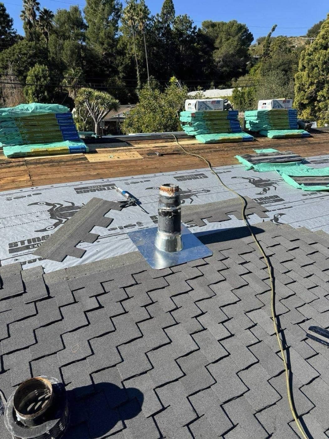 CertainTeed Presidential shingle bundles staged on roof with synthetic underlayment installed