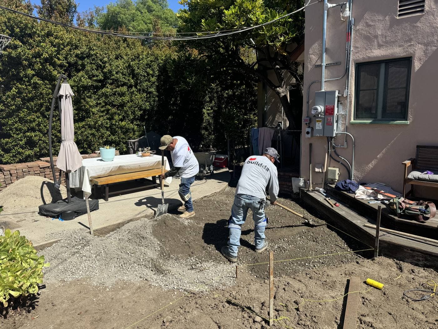 Mason guide strings above prepared mortar base ready for reclaimed brick walkway installation in Culver City