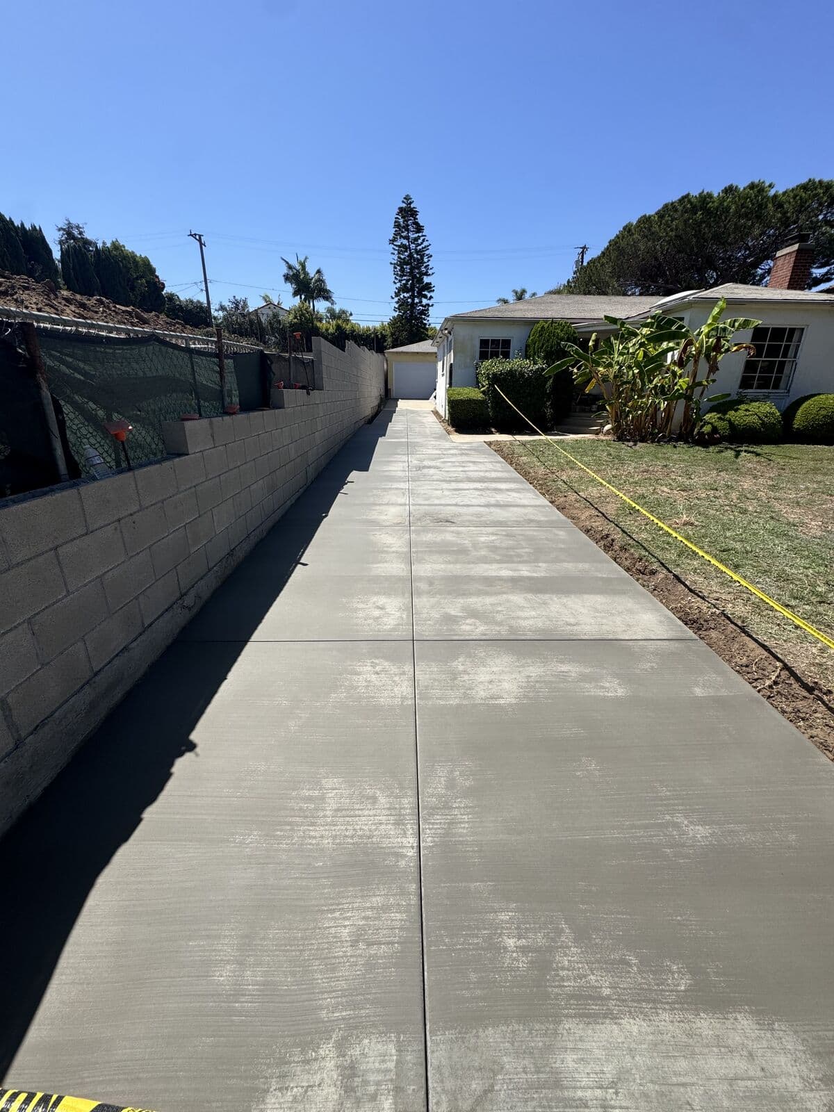 New broom-finish concrete driveway running to the street in Santa Monica
