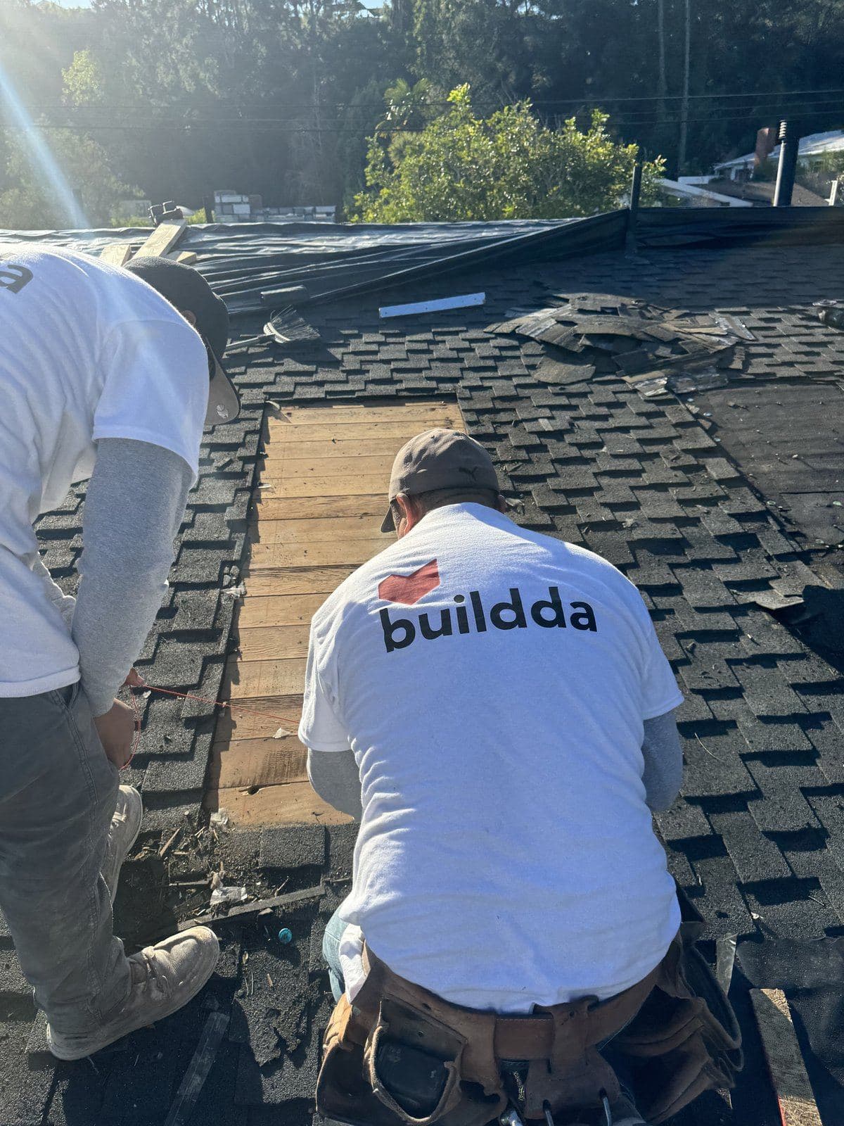 Buildda crew tearing off old shingles, Brentwood