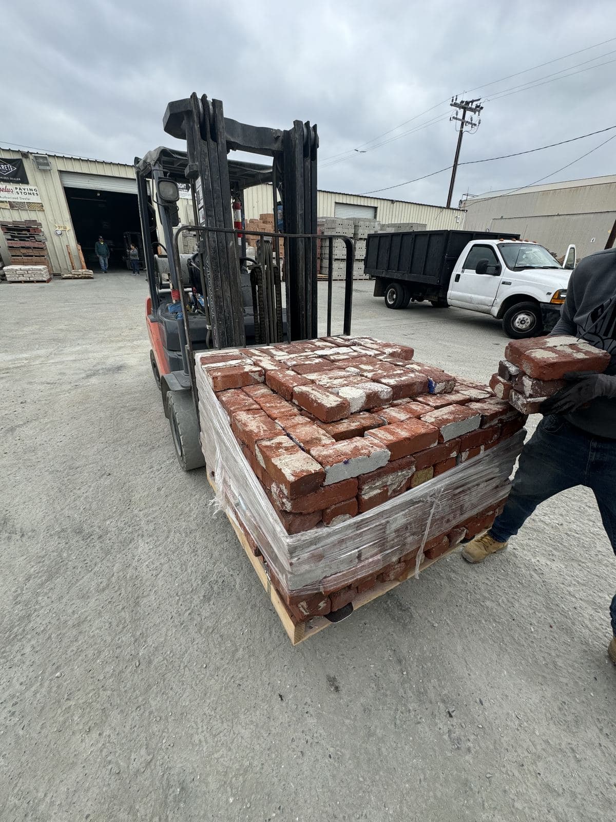 Forklift loading pallet of reclaimed bricks at LA area salvage yard for Buildda Culver City project