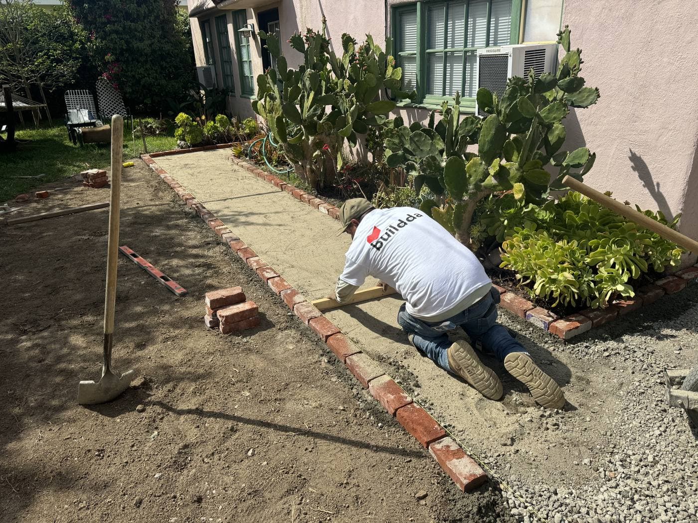 Buildda crew laying reclaimed bricks in running bond pattern in Culver City backyard