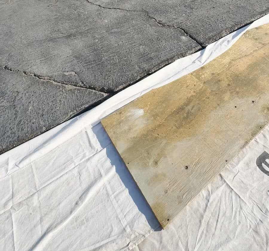 Cracked old asphalt driveway in Culver City before Buildda replaced it with concrete