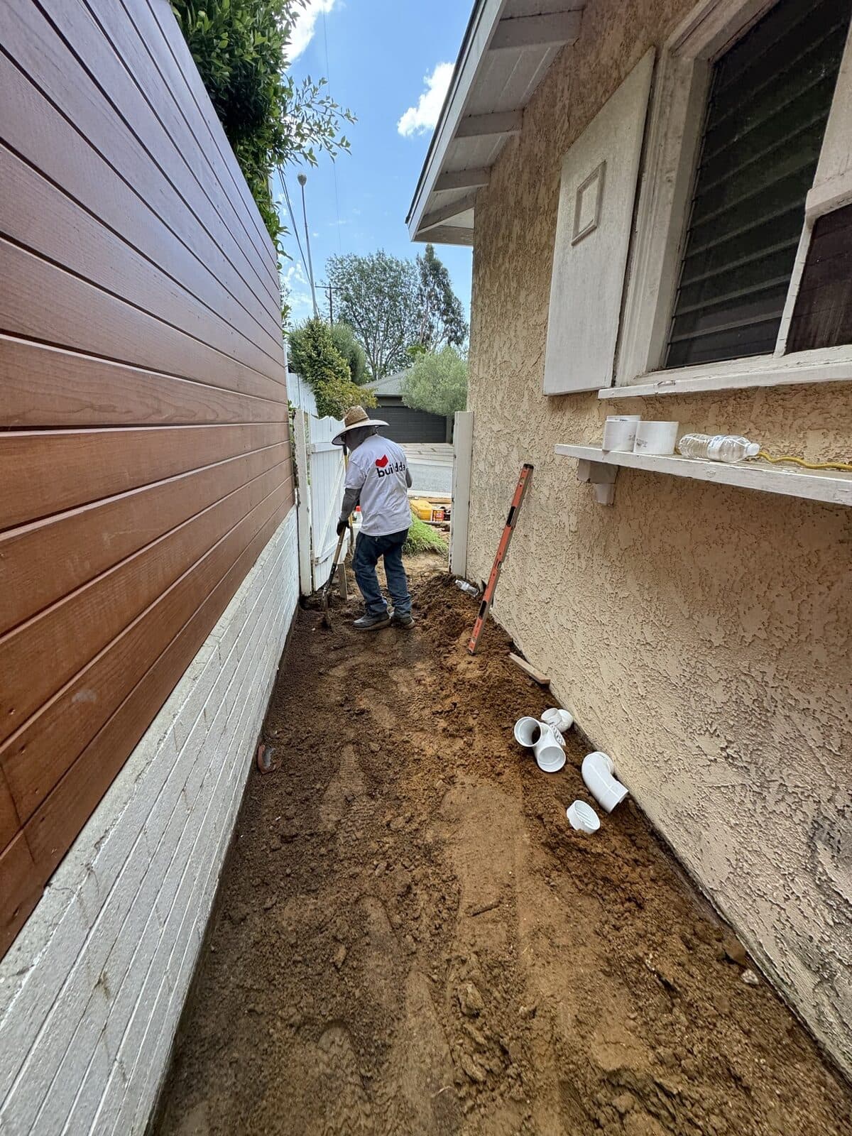 Trench dug along the side yard for the new drain line in Culver City