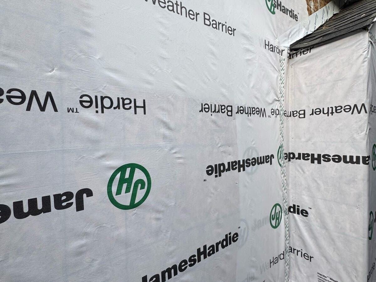 Weather barrier covering new sheathing before the fiber-cement siding on a Palms home