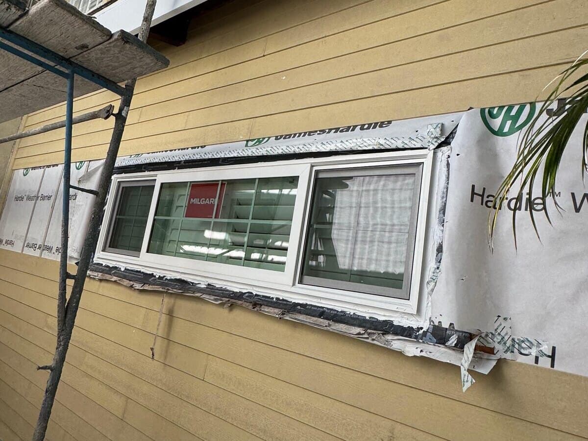 New window flashed into the weather barrier with fiber-cement siding below on a Palms home