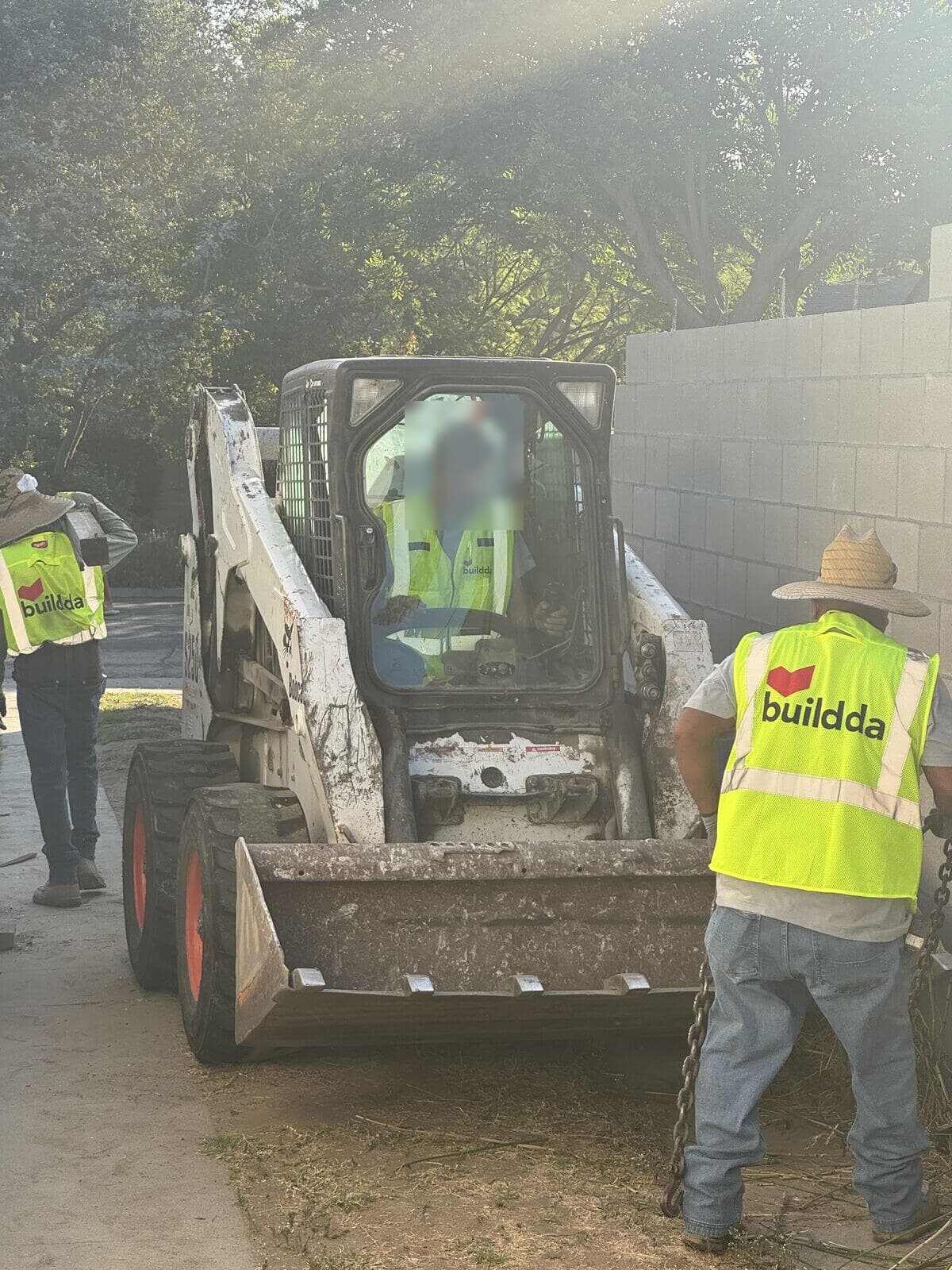 Skid steer and Buildda crew breaking out an old concrete strip driveway in Santa Monica