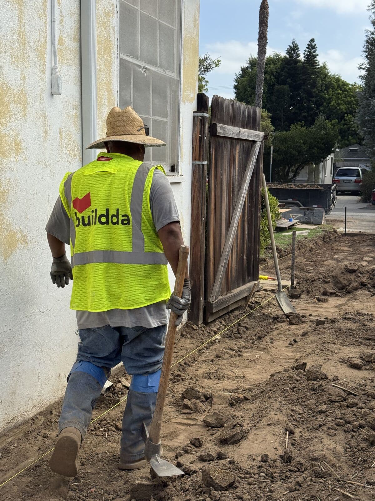 Buildda crew member digging out the side yard for a new concrete driveway in Santa Monica