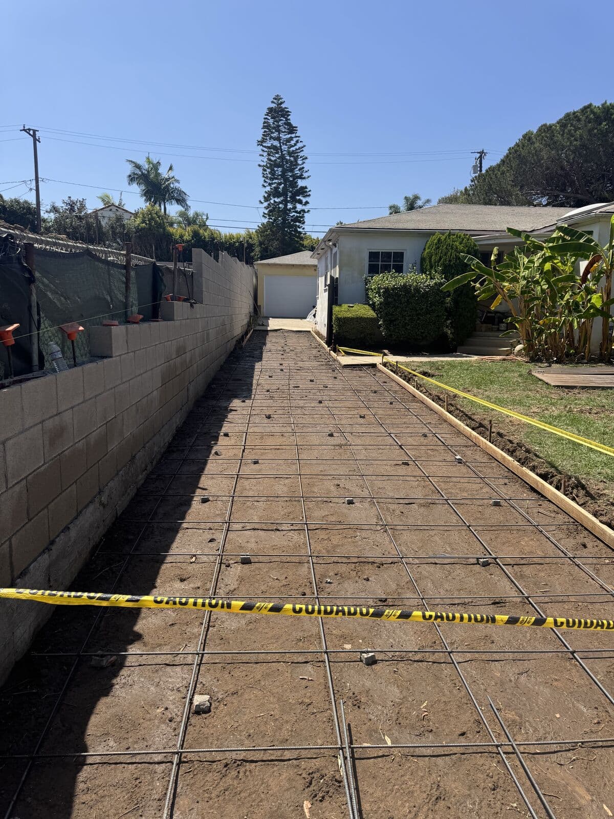 Forms and steel grid set the full length of a new driveway before the concrete pour in Santa Monica